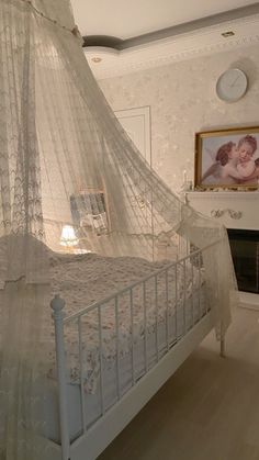 a white bed sitting in a bedroom next to a painting on the wall above it