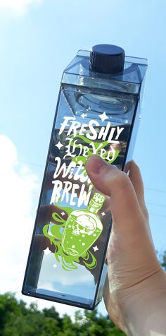 a person holding up a water bottle that says freshy for you and drink brew