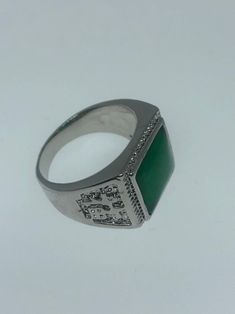 Large green nephrite jade Ornate German Silver Vintage ring, does not tarnish, NOT sterling Has Chinese lettering for luck on the sides. Sizes 8, 9 10 or 11 All rings are shipped in a nice gift box. Check out our over a THOUSAND great reviews Engraving is $4 per letter and is not always perfect depending on the piece. It can take a few days if the jeweler is busy. This is payable to Paypal Judithsltd@gmail.com Green Rectangular Signet Ring For Formal Occasions, Symbolic Green Gemstone Jewelry, Green Signet Ring With Polished Finish For May Birthstone, Classic Green Signet Ring Stamped 925, Green Engraved Ring As Gift, Green Engraved Ring As A Gift, Classic Green Engraved Signet Ring, Formal Green Engraved Signet Ring, Hallmarked Green Rectangular Rings