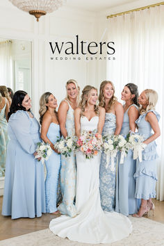 a group of women standing next to each other in front of a mirror holding bouquets