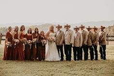 a group of people standing next to each other in front of a fenced in field