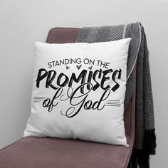 a white pillow sitting on top of a chair next to a throw pillow that says, standing on the promises of god