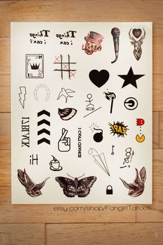 a sheet of paper that has various tattoos on it, including an arrow and other symbols