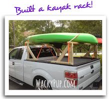 a white truck with a green kayak on the back