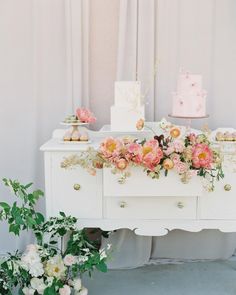 a table with flowers and cakes on it