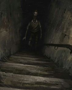 a man walking up some stairs in the dark