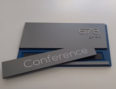 two business cards sitting on top of each other with the word conference printed on them