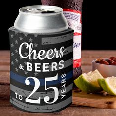 a can of beer next to some food on a cutting board with an american flag design