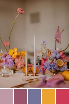 a table topped with lots of flowers and candles