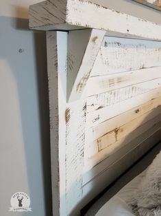 a white headboard made out of old wood