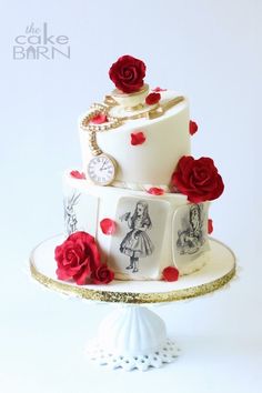 a three tiered cake with red roses on it