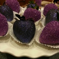 there are some purple heart shaped treats on the plate