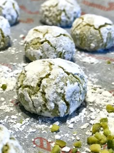 there are several cookies that have been covered in powdered sugar and pistachio