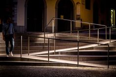 a man walking up some stairs at night