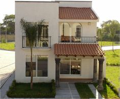 a white house with two balconies and palm trees