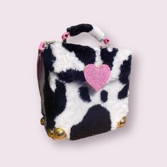 The Milkshake Box Bag is the perfect accessory for any cow-loving coquette cutie. With a black and white cow print fur exterior, gold hardware, pink glitter heart closure and matching pink glitter interior, you'll be the talk of the town. Plus, it has an adjustable strap, so you can carry it however you like! Moo-ve fast - this bag won't last long! Shown in size 'Midi'. Dimensions are (approx): Baby: 14cm (w) x 14cm (h) x 7cm (depth) Mini: 16cm (w) x 17cm (h) x 8cm (depth) Midi: 22cm (w) x 19cm Glitter Interior, Aliyah Core, Black And White Cow Print, Y2k Black And White, White Cow Print, Black And White Cow, Core Outfits, Bag Y2k, Vintage Style Christmas