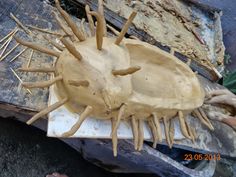 a wooden object that looks like a hedgehog with spikes on it's head