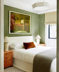 a bedroom with green walls and white bedding