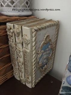 an old book sitting on top of a wooden table next to baskets and other items