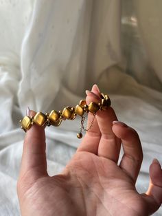 A truly rare, museum- quality adornment, this 19th century “North Star” bracelet is a classic archaeological revival design. Crafted circa 1870 in 15 carat gold, this bracelet features a stunning 14 gold panels clasped together by delicate boules. At the center of each panel is a beautiful miniature white gold .35ct diamond, bezel set against fine, star-shaped engraving. Star motifs like the one on this bracelet occurred frequently in 1870’s jewelry. This bracelet underscores the playful element Elegant Bronze Bangle Bracelet, Gold Brass Bangle Bracelet For Formal Occasions, Formal Gold Brass Bracelet, Formal Gold Brass Bracelets, Ceremonial Yellow Gold Jubilee Bracelet, Antique Gold Bangle For Formal Occasions, Elegant Antique Gold Metal Bracelets, Elegant Antique Gold Metal Bracelet, Bronze Bracelet For Formal Occasion