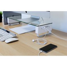 a desk with a keyboard, mouse and phone on it