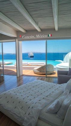 a bedroom with an ocean view is shown