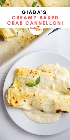 a white plate topped with cheese covered crepes