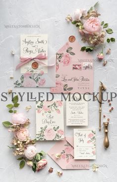 the wedding stationery is laid out with flowers and ribbons on it, including pink roses