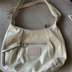 Never Used. Got As A Big Bday Gift And It Sat In My Closet. It’s Never Even Been Outside After It’s Purchase!! Small Mark On The Back Left Area Made During Moving We Think. A Silver/Gold Finish - I’m Not Sure How To Describe. Coach Silver Shoulder Bag For Everyday, Coach Silver Bag With Adjustable Strap, Silver Coach Bag With Adjustable Strap, Coach Swagger 27, Coach Parker, Coach Leather Bag, Canvas Leather Bag, Bday Gift, Leather Duffle Bag