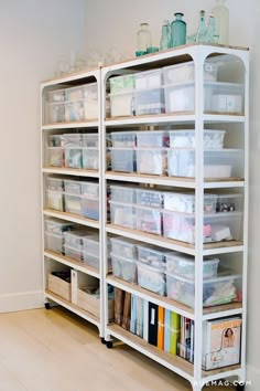 the shelves are filled with plastic containers and other items for storage on top of them