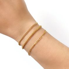 It's the perfect layering, stacking bracelet! Wear it alone, or layered with your other favourite pieces. Material 14 Karat Gold Filled. Nickel free. Suitable for sensitive skin. Quantity & Measurement One link chain bracelet Adjustable length: 6.5 +1 inches extension Closure: Parrot clasp * Bracelet for layering purposes only. Sold separately. Trendy Adjustable Charm Bracelet With Delicate Chain, Dainty Delicate Chain Bracelets For Layering, Dainty Bracelets For Layering, Trendy Charm Bracelet With Delicate Chain, Minimalist Stackable Chain Bracelet For Layering, Layering Bracelets With Delicate Chain, Trendy Adjustable Gold Bracelet With Delicate Chain, Everyday Dainty Stackable Chain Bracelet, Trendy Adjustable Delicate Chain Bracelet