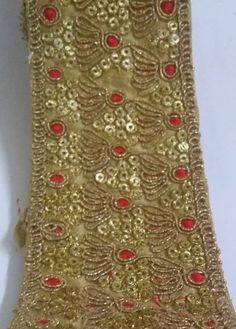 gold sequins with red stones on it