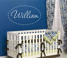 a baby crib in front of a blue wall with the name william on it