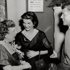 an old photo of three women talking to each other