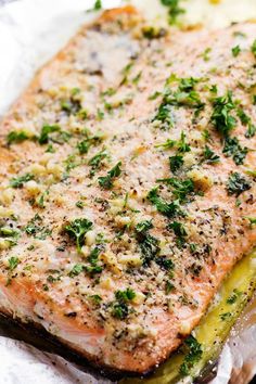 a close up of a piece of fish on a plate with broccoli and cheese