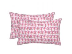 two pillows with pink and white designs on them