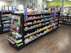 an aisle in a grocery store filled with lots of food and drink bottles on the shelves