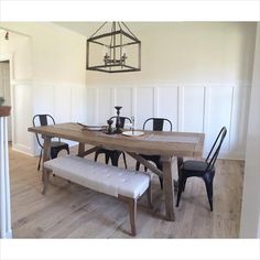 a dining room table with chairs and a bench