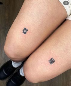 two legs with small tattoos on them and one is showing the same tattoo as the other