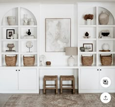 a living room filled with lots of white furniture and shelves covered in baskets on top of them