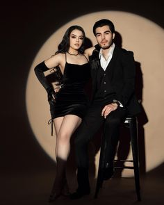 a man and woman posing for a photo in front of a full moon