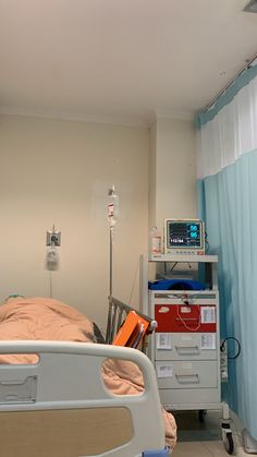 a hospital room with a bed and medical equipment