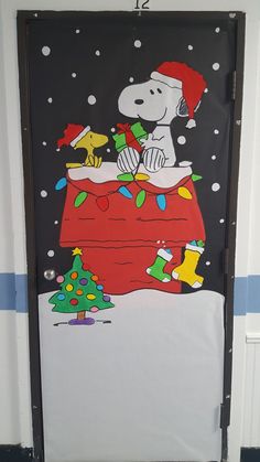 a door decorated with a snoopy christmas scene