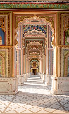 an intricately decorated hallway with paintings on the walls