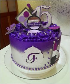 a cake with purple icing and decorations on it