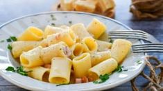 a white plate topped with pasta and cheese