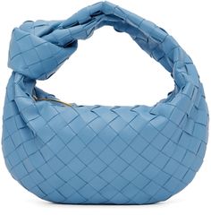 Intrecciato-woven grained lambskin top handle bag in blue. · Knot detailing at fixed carry handle · Zip closure · Buffed calfskin lining · H6 x W9.5 x D3 in Supplier color: Windswept/Gold Designer Blue Shoulder Bag With Woven Leather, Designer Blue Woven Leather Shoulder Bag, Chic Blue Bag With Intrecciato Weave, Designer Blue Shoulder Bag With Braided Handles, Designer Blue Bags With Braided Handles, Modern Blue Woven Leather Bag, Luxury Blue Shoulder Bag With Braided Handles, Elegant Blue Woven Leather Shoulder Bag, Blue Top Handle Bag With Intrecciato Weave