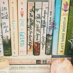 a book shelf filled with lots of books and a donut on top of it