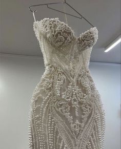 a white dress hanging on a clothes rack