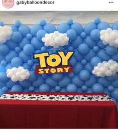 the balloon wall is decorated with blue and white balloons that say toy story on it